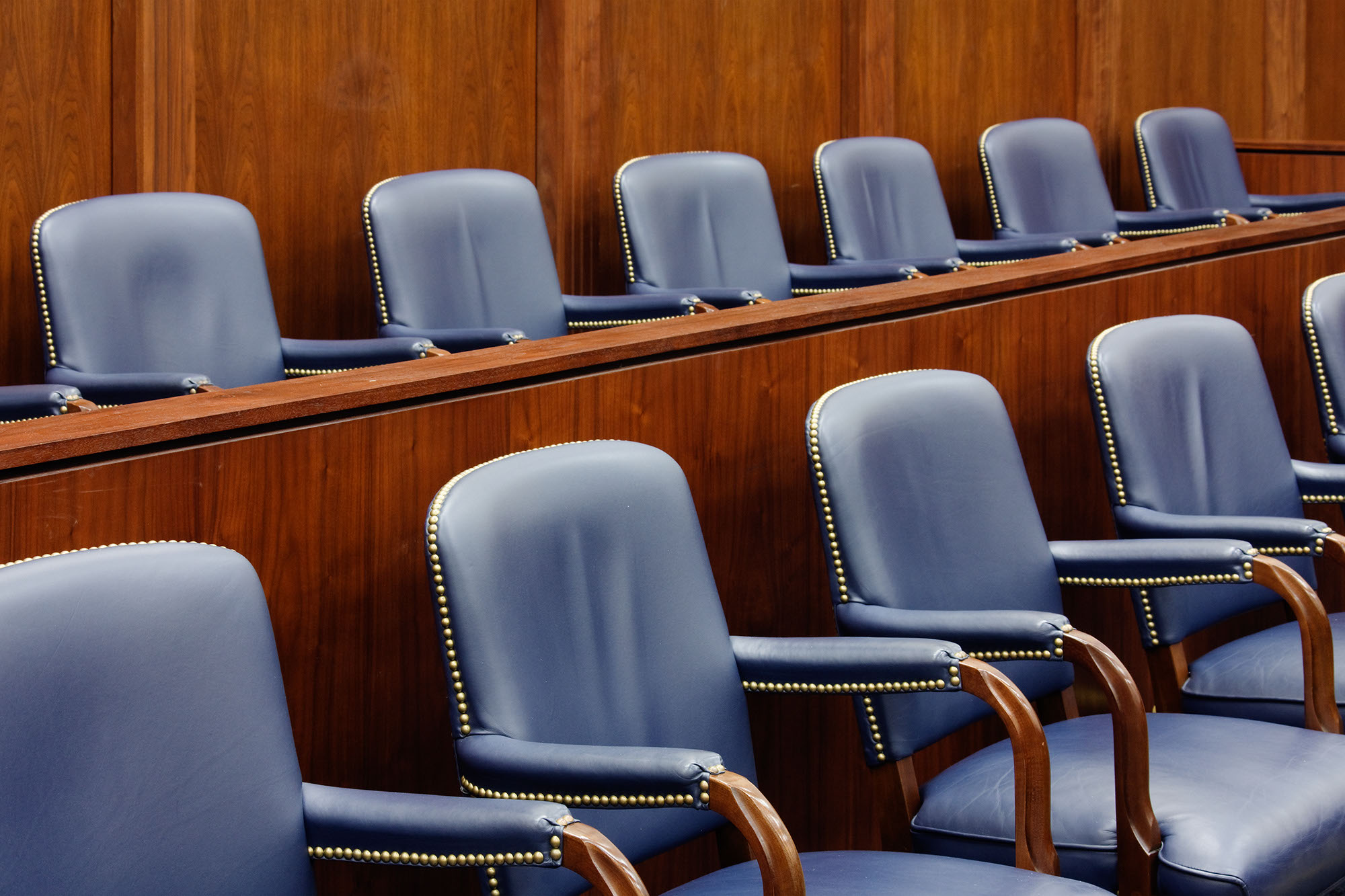A stock phot of two rows of empty jury seats in a courtroom