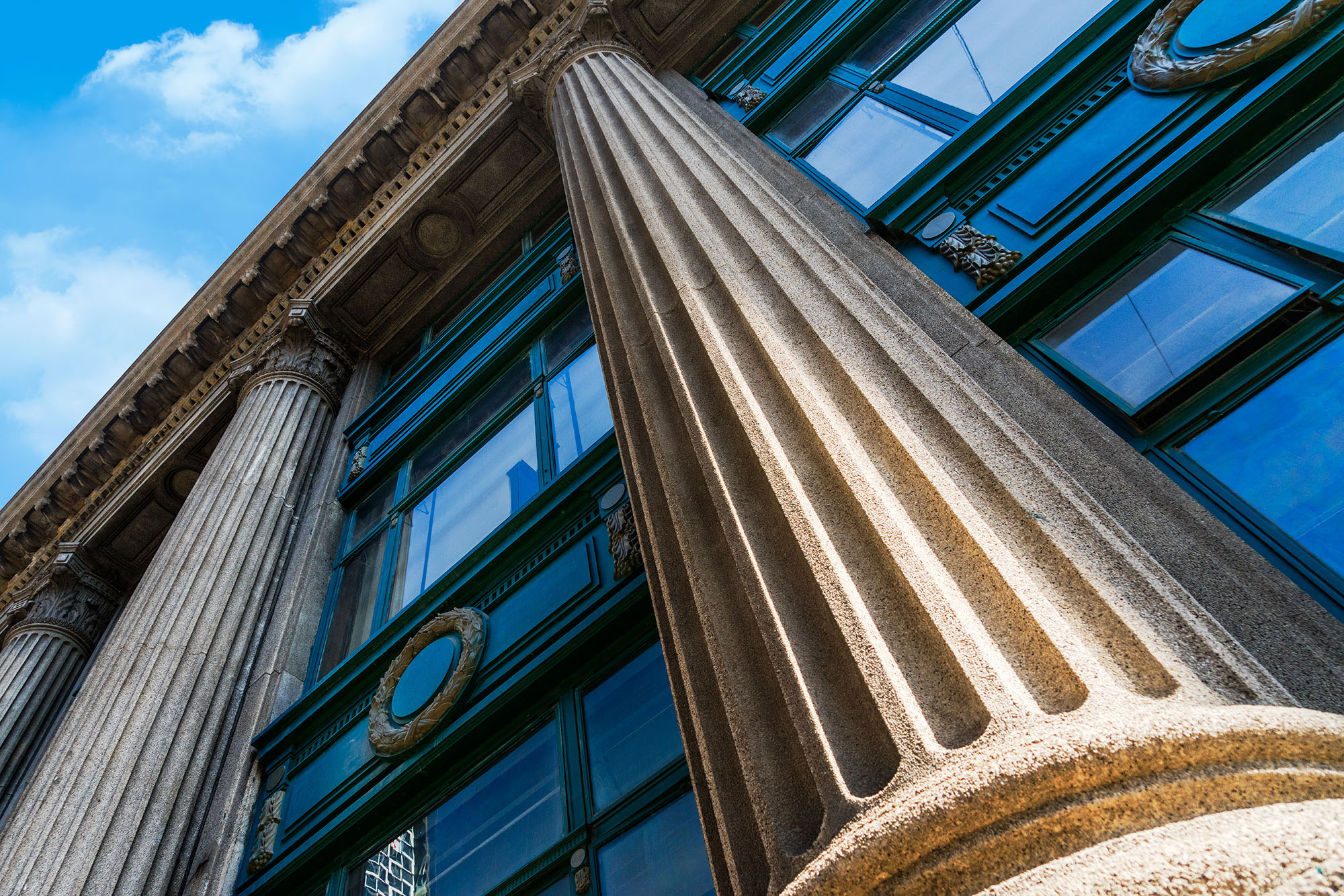 A stock image of a building with grey marble columns in Shanghai, China