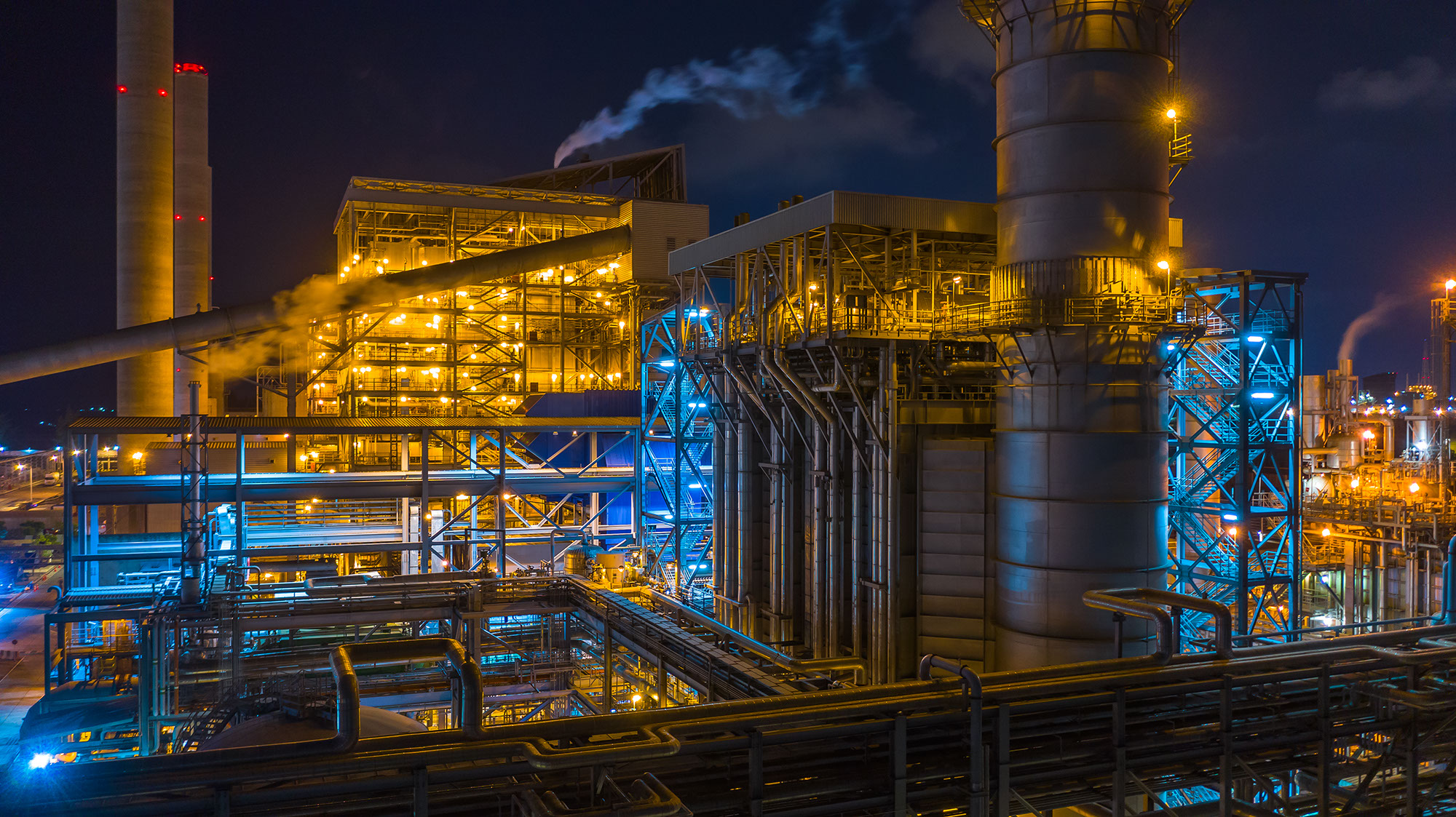 A stock image of a power station at a combined heat power plant at night