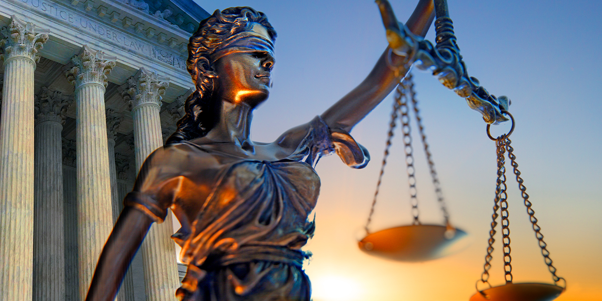 A stock image of Lady Liberty holding the scales of justice in front of the Supreme Court