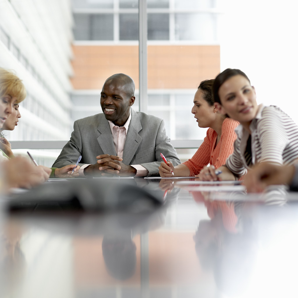 A stock photo of five businesspeople in a meeting